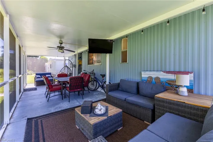 wrap around patio with outdoor lounge area, outdoor dining area, and ceiling fan