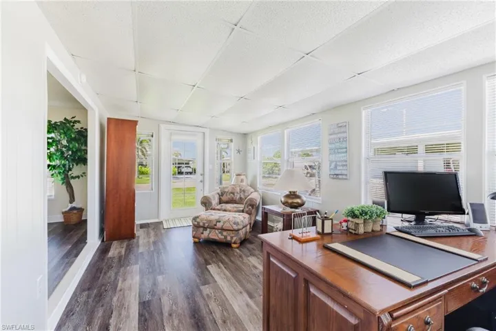 Office area featuring a paneled ceiling and dark wood finished floors