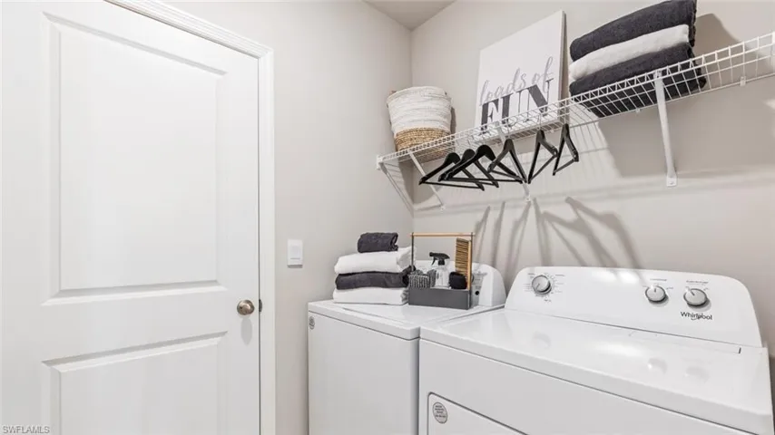 Model home. Laundry area with washer and clothes dryer