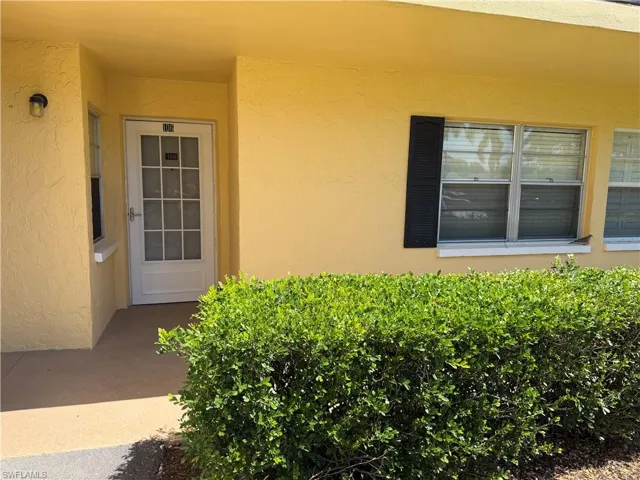 Entrance to property featuring stucco siding