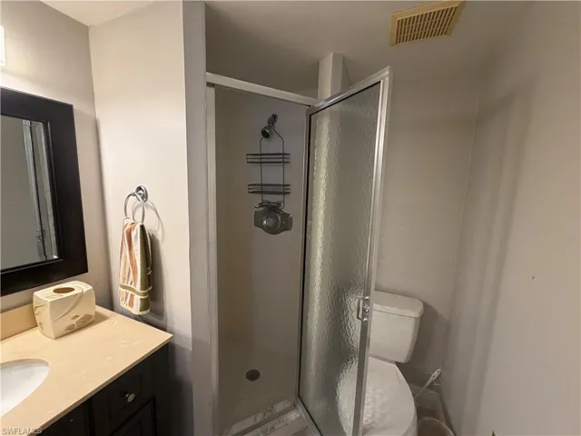 Bathroom with vanity and a stall shower