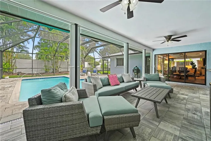 Sunroom featuring an outdoor living space, a patio, and a ceiling fan