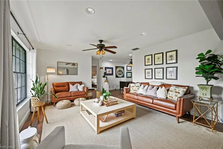 Living room with recessed lighting, wood finished floors, and ceiling fan