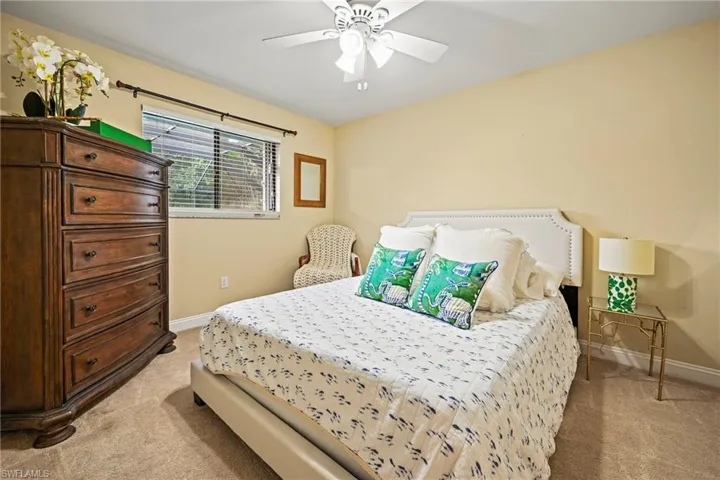 Bedroom featuring light colored carpet and a ceiling fan