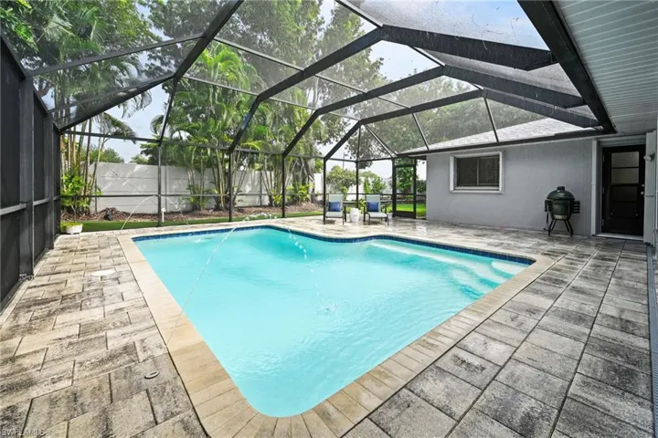 View of swimming pool with a lanai, a patio & plenty of entertining room