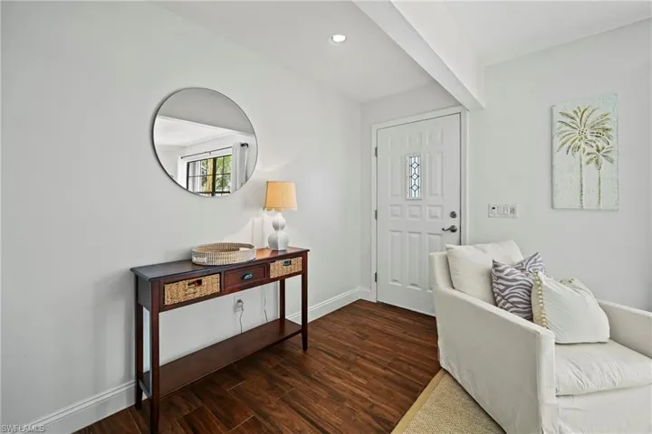 Entrance foyer with dark wood-style floors and recessed lighting
