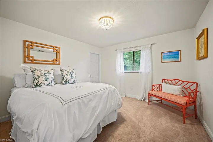 Carpeted bedroom featuring baseboards
