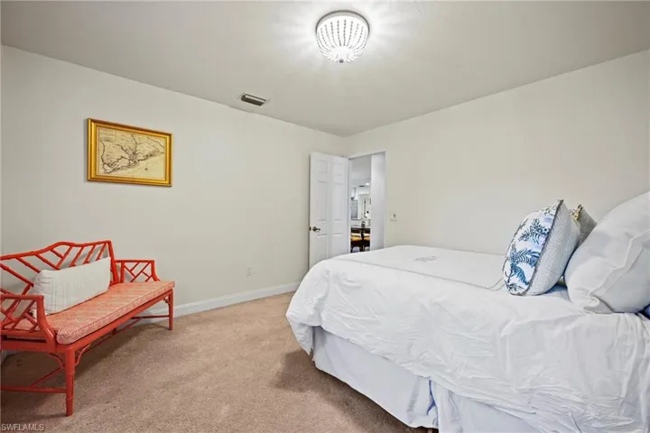Carpeted bedroom featuring baseboards