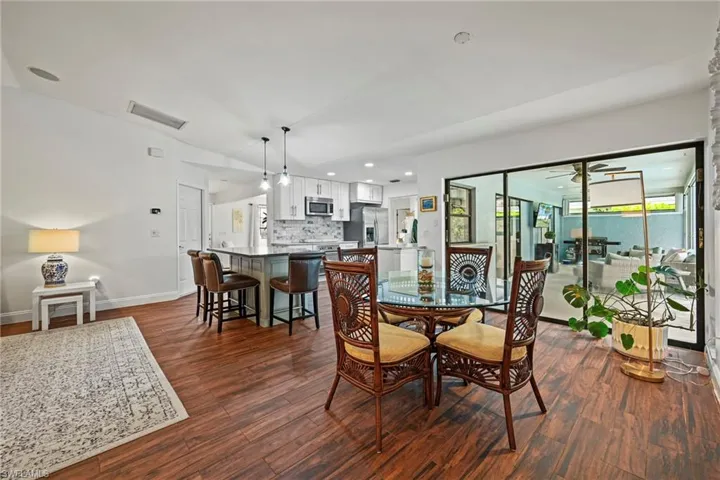 Dining area featuring dark wood-style flooring, recessed lighting, and a ceiling fan