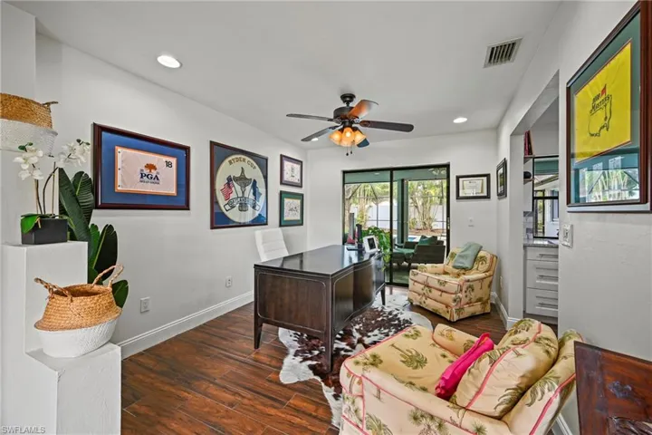 Office area featuring dark wood-type flooring, recessed lighting, and a ceiling fan
