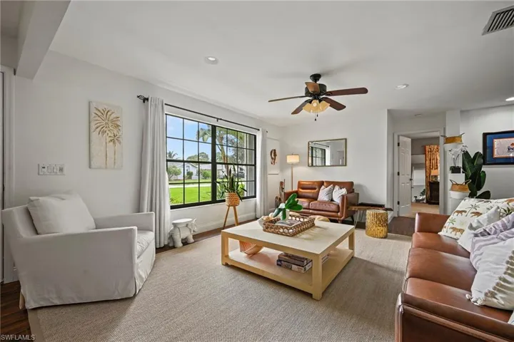 Living room with recessed lighting, wood finished floors, and a ceiling fan