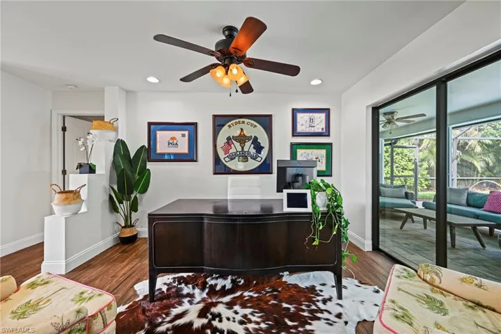 Office area featuring dark wood-style floors, recessed lighting, and a ceiling fan