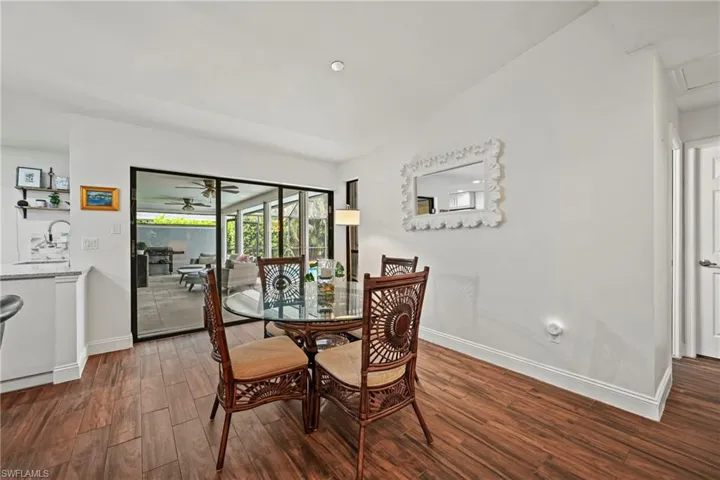 Dining room with dark wood-style floors and ceiling fan