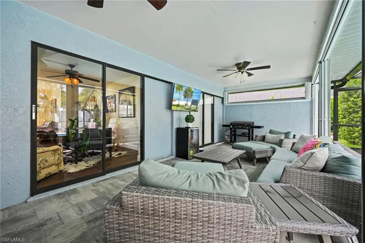 Shaded Patio featuring ceiling fan, an outdoor hangout area, and healthy amount of natural light
