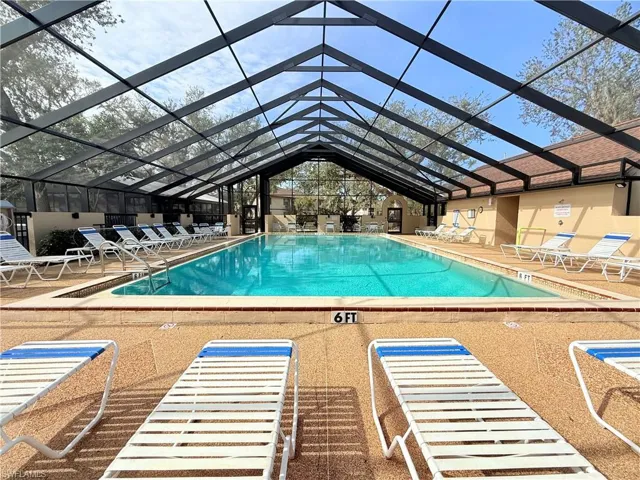 View of swimming pool with a patio and a lanai