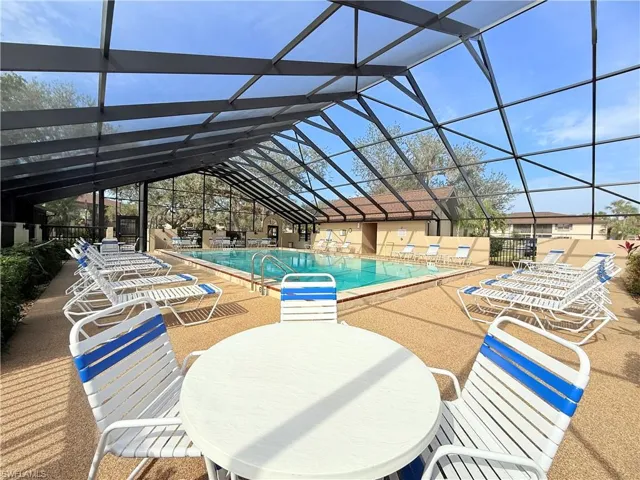 View of swimming pool featuring a lanai and a patio