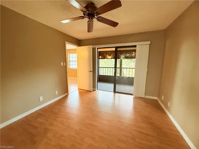 Spare room with a textured ceiling, light hardwood / wood-style flooring, and ceiling fan