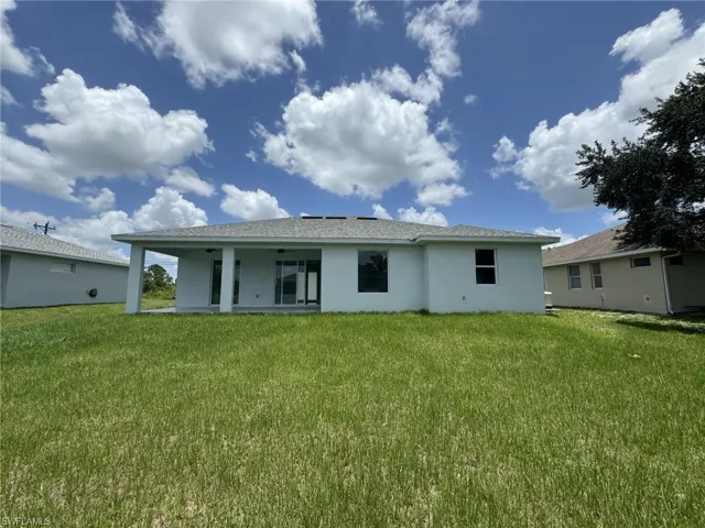 Back of house featuring a yard