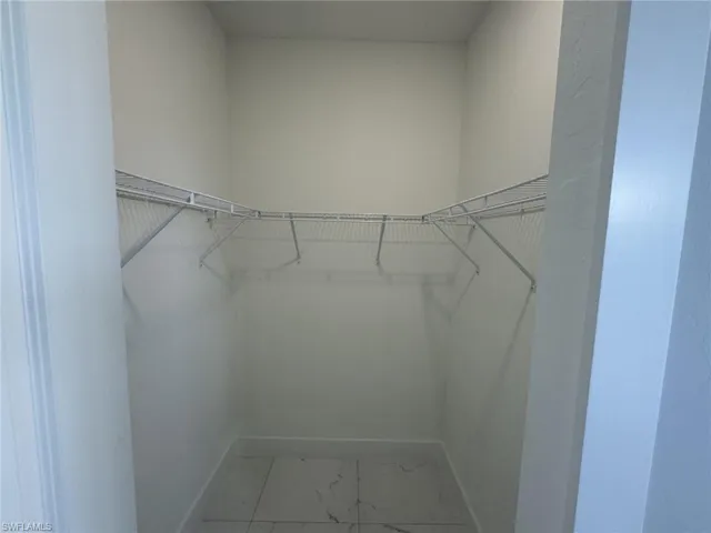 Spacious closet featuring tile patterned flooring