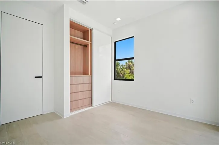 Unfurnished bedroom featuring light wood-style flooring and baseboards