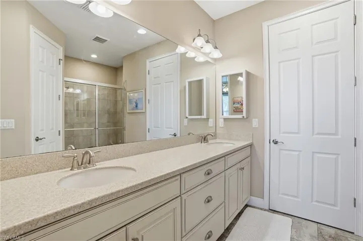 Double vanity featuring undermount sinks, brushed nickel fixtures, and a speckled countertop