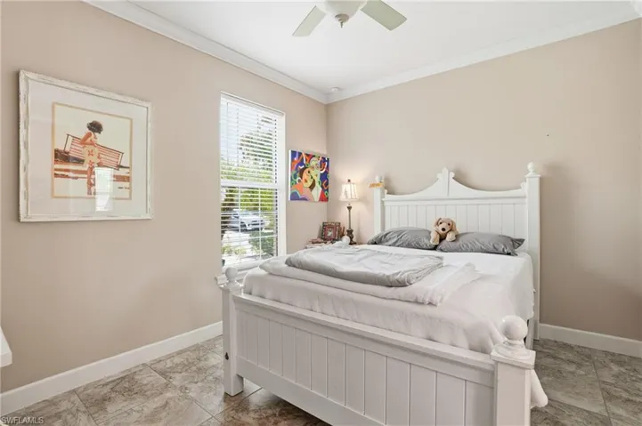 Bright room featuring a window with blinds, a ceiling fan, crown molding, tile flooring, and neutral wall paint
