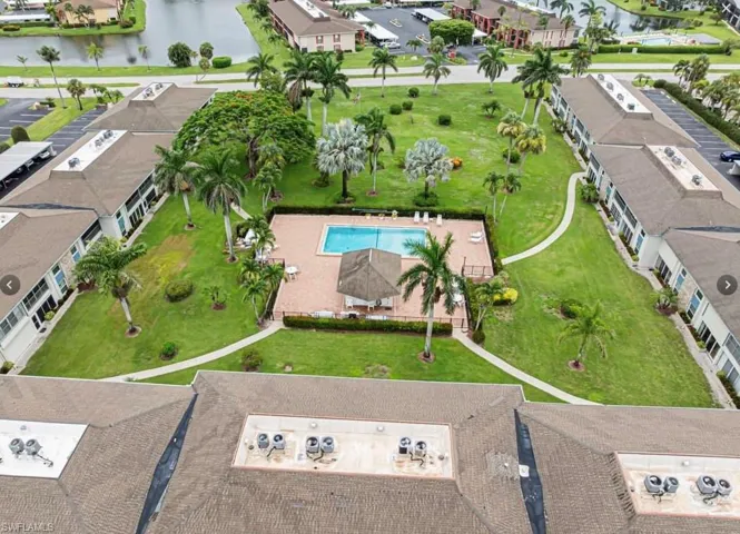 Aerial view of the courtyard, community pool and tiki hut.