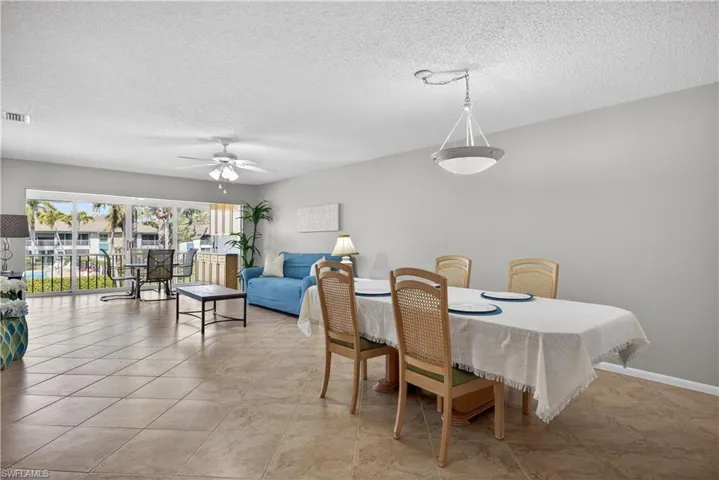 Dining room with overhead lighting and matching tile floors throughout