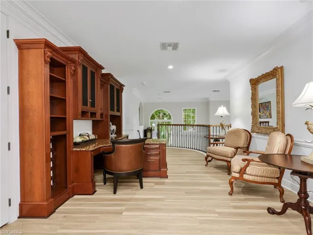 Upstairs loft area with built-in office desk, and shelving