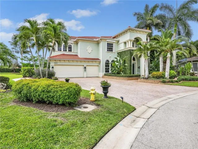 Extra large paver driveway with three car garage