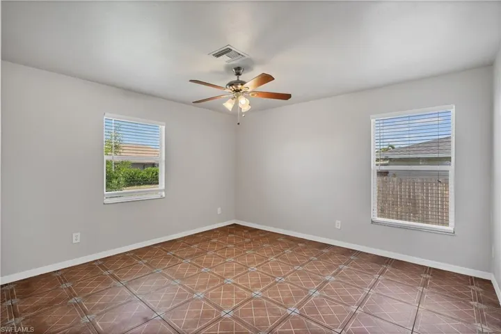 Light gray walls with patterned tile flooring