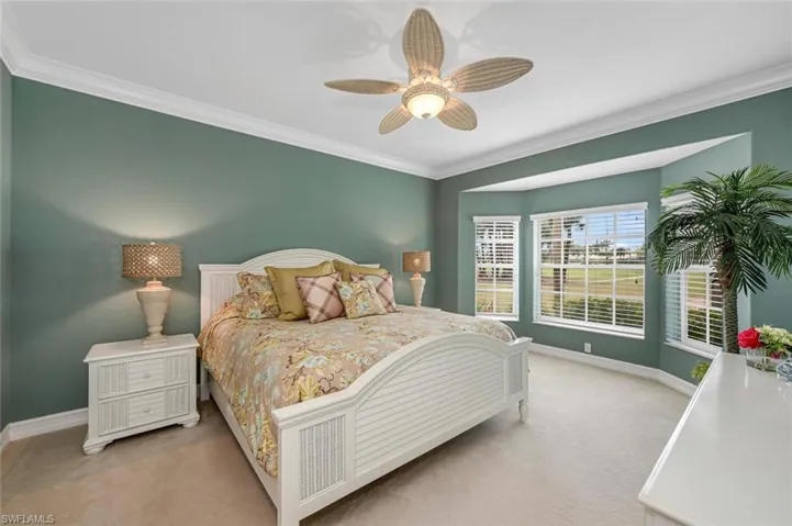 Bedroom with baseboards, carpet floors, a ceiling fan, and crown molding