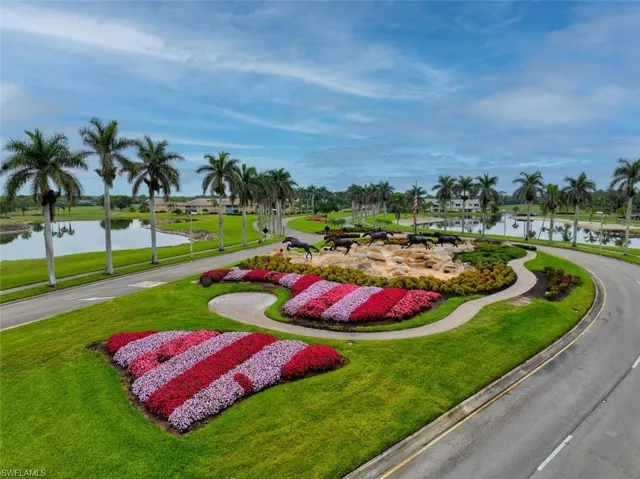 Surrounding community with a water view and a yard