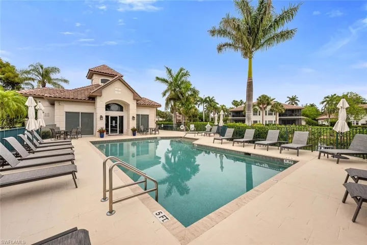 Community pool featuring fence and a patio