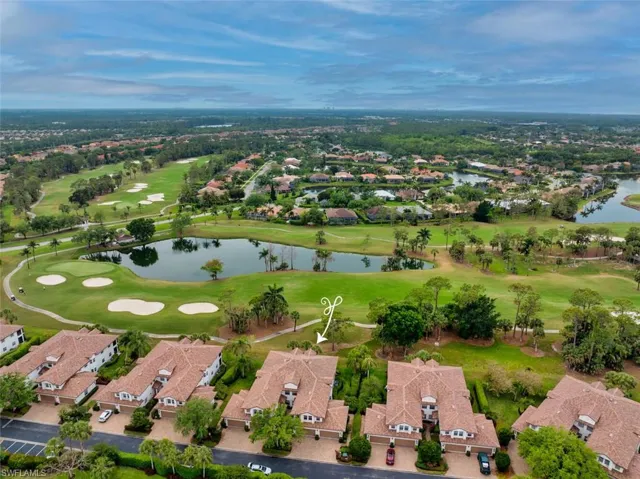 Drone / aerial view with golf course view, a water view, and a residential view