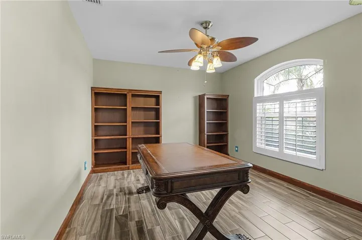 Office space with ceiling fan and light hardwood / wood-style flooring