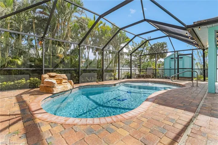 View of pool with a storage unit, a lanai, and a patio area
