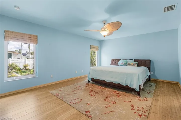 Bedroom featuring ceiling fan and hardwood / wood-style floors