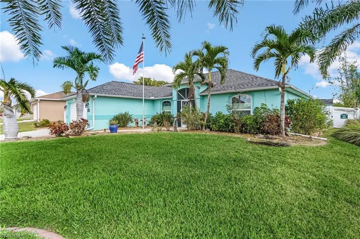 Ranch-style home featuring a front lawn