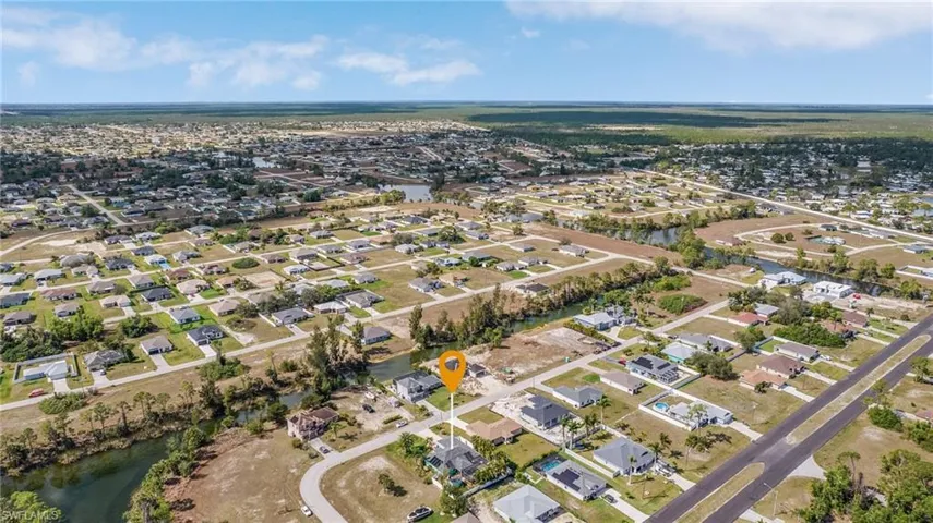 Birds eye view of property with a water view