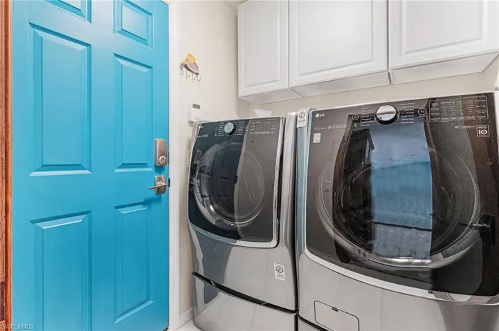 Washroom featuring cabinets and separate washer and dryer