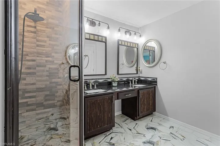 Bathroom with vanity and a tile shower