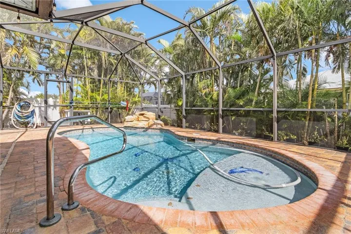 View of swimming pool with a patio and a lanai