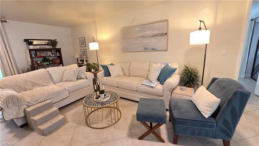 Bright living area featuring neutral-toned walls and tile flooring
