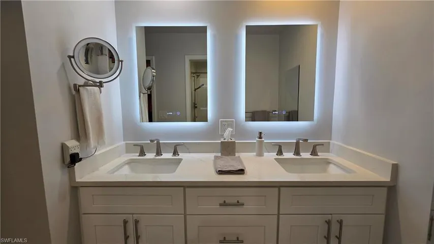 Dual vanity with integrated sinks and brushed nickel fixtures