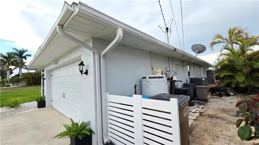 White garage door with panel detailing and sconce lighting