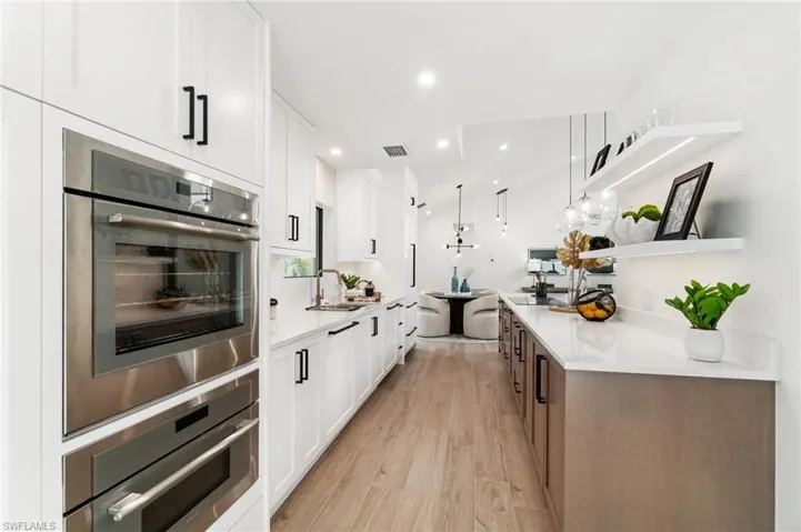 Shaker cabinets with soft-close doors and drawers, quartz counters