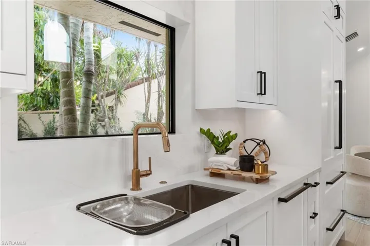 Details such as backsplash quartz, enframing the window, rose gold fixtures.  Stunning!