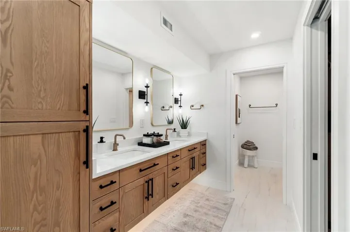 Exquisite spa bath. Quartz counter, rose-godl fixtures, under-cabinet lighting, storage mirrors