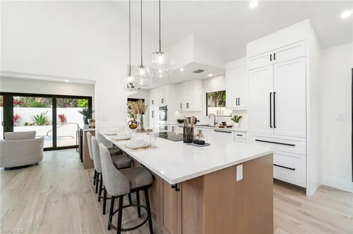 Oversized island with quartz counter top, seating and electric cook top - ideal for entertaining